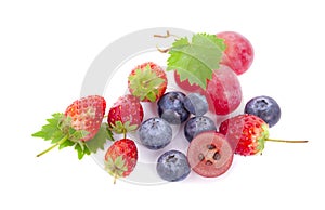 Mix berries isolated on a white. Ripe blueberries, red currants, raspberries and strawberries. Various fresh summer berries on