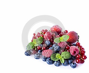 Mix berries isolated on a white. Ripe blueberries, red currants, raspberries and strawberries. Various fresh summer berries on whi