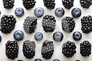 Mix berries patern over white background. Blackberries and blueberries.