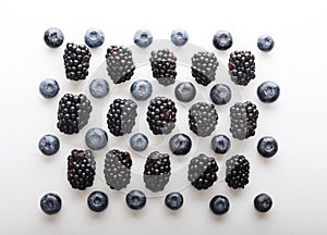 Mix berries patern over white background. Blackberries and blueberries.