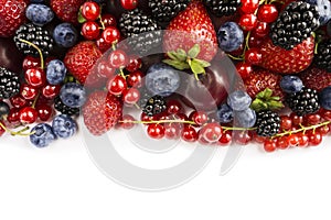 Mix berries on a white background. Berries and fruits with copy space for text. Black-blue and red food. Ripe blackberries, bluebe