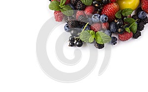 Mix berries on a white background. Berries and fruits at border of image with copy space for text. Black-blue and red food. Ripe b