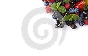 Mix berries on a white background. Berries and fruits at border of image with copy space for text. Black-blue and red food. Ripe b