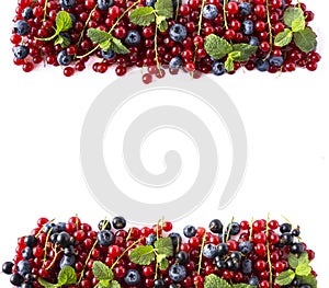 Mix berries on a white background. Ripe red currants, blueberries, black currants with mint leaves on white background.