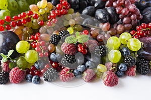 Mix berries on a white background. Ripe red currants, grapes, blackberries, blueberries and raspberries on white background. Top v