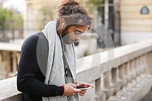 Mix blood music lover enjoying new earphones and smartphone nea