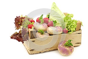 Mix of cabbage, lettuce and turnips in a wooden crate