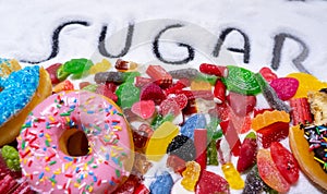 Mix of candies donuts and sugar in writing