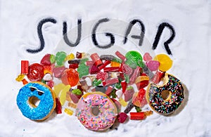 Mix of candies donuts and sugar in writing