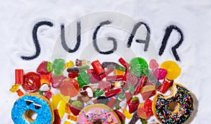 Mix of candies donuts and sugar in writing