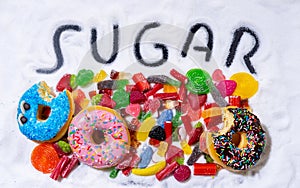 Mix of candies donuts and sugar in writing