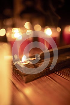 Mix candles, incense and lanterns on rustic wood table