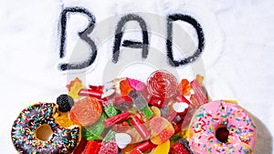 Mix of candy donut sugar word bad written