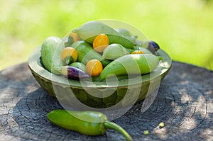 Mix of chilli, achocha and jalapenos in wooden bowl