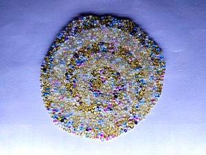 Mix of colorful glass seed beads on white background