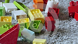 Mix of Colourful Pieces of Lego sitting on mat indoors