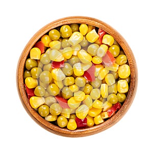 Mix of canned corn, green peas and diced red bell pepper, in a wooden bowl