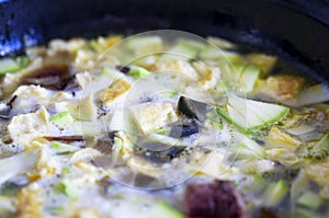 Mix cuted up vegetables and meats and eggs in pan