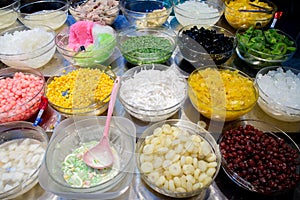 Mix dessert with ice, sweet and herb on sale. Varieties of colorful Thai dessert. Topping mixed for Thai ice dessert.