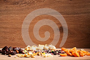 Mix of different dried fruits on wooden background