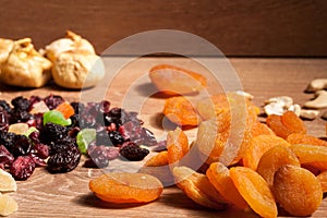 Mix of different dried fruits on wooden background