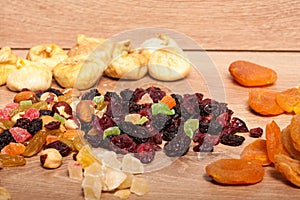 Mix of different dried fruits on wooden background