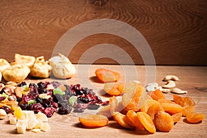 Mix of different dried fruits on wooden background