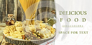 A mix of different types of pasta on a wooden background