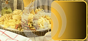 A mix of different types of pasta on a wooden background