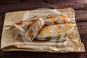 Mix of different varieties of bread lying on a wooden table