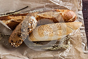 Mix of different varieties of bread lying on a wooden table