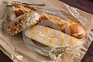 Mix of different varieties of bread lying on a wooden table