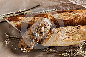 Mix of different varieties of bread lying on a wooden table