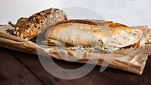 Mix of different varieties of bread lying on a wooden table