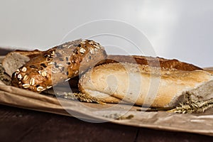 Mix of different varieties of bread lying on a wooden table