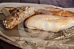 Mix of different varieties of bread lying on a wooden table
