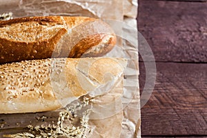 Mix of different varieties of bread lying on a wooden table