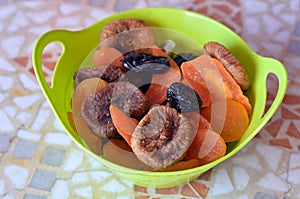 Mix of dried fruits in a green bowl during the Jewish holiday Tu