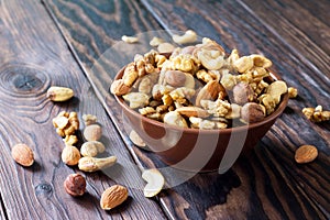 Mix of dried fruits and nuts on a wooden background. The concept of a healthy dessert