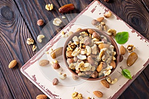 Mix of dried fruits and nuts on a wooden background. The concept of a healthy dessert