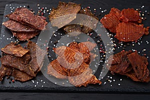 Mix of dried meat Jerky . From chicken , beef and pork