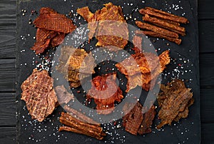 Mix of dried meat Jerky . From chicken , beef and pork