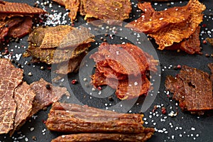 Mix of dried meat Jerky . From chicken , beef and pork