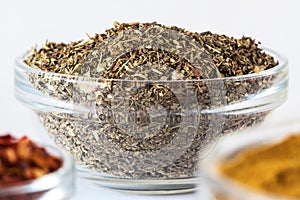 Mix of dry Italian Herbs in glass bowl. Blend of Italian Cuisine. Macrophotography