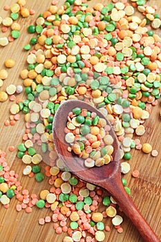 Mix of dry peas in old wooden spoon