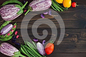 Mix of fresh farmers market vegetable from above on the old wooden board with copy space. Healthy eating background. Top view