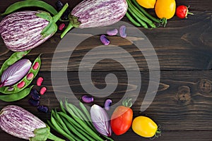 Mix of fresh farmers market vegetable from above on the old wooden board with copy space. Healthy eating background. Top view