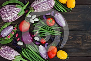 Mix of fresh farmers market vegetable from above on the old wooden board with copy space. Healthy eating background. Top view