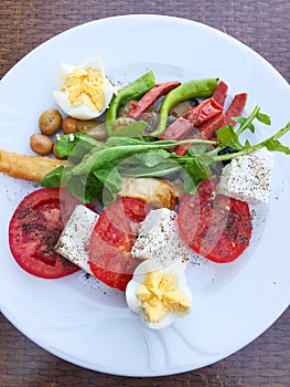 mix of fresh vegetables, herbs, spices and eggs on a plate.