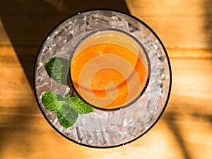 Mix fruite juice in glass with ice put on wood table